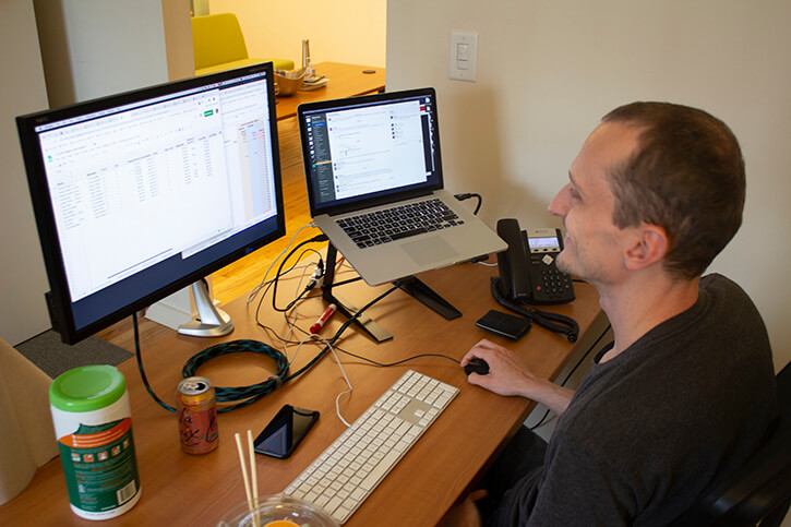 components/Colin_working_on_computer_at_desk_devops_component_optimized.jpg