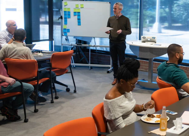components/Caktus_group_listens_to_presenter.jpg